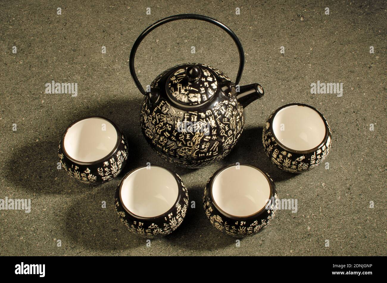 Traditional Kettle and tea Set with Chinese Script . Top angle. Studio