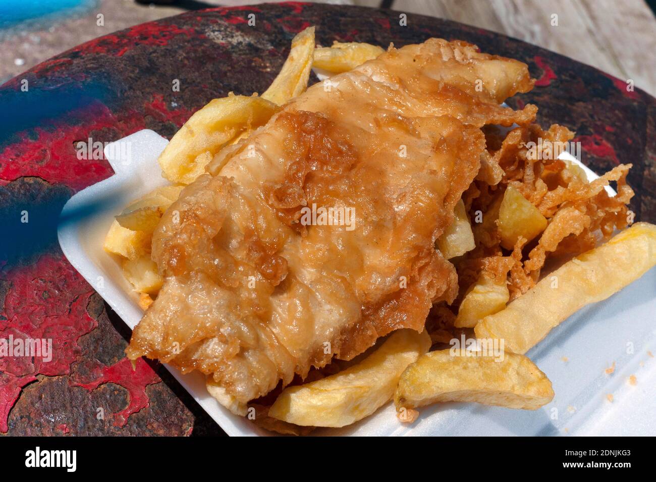 Fish and Chips on Seahouses harbour wall Stock Photo