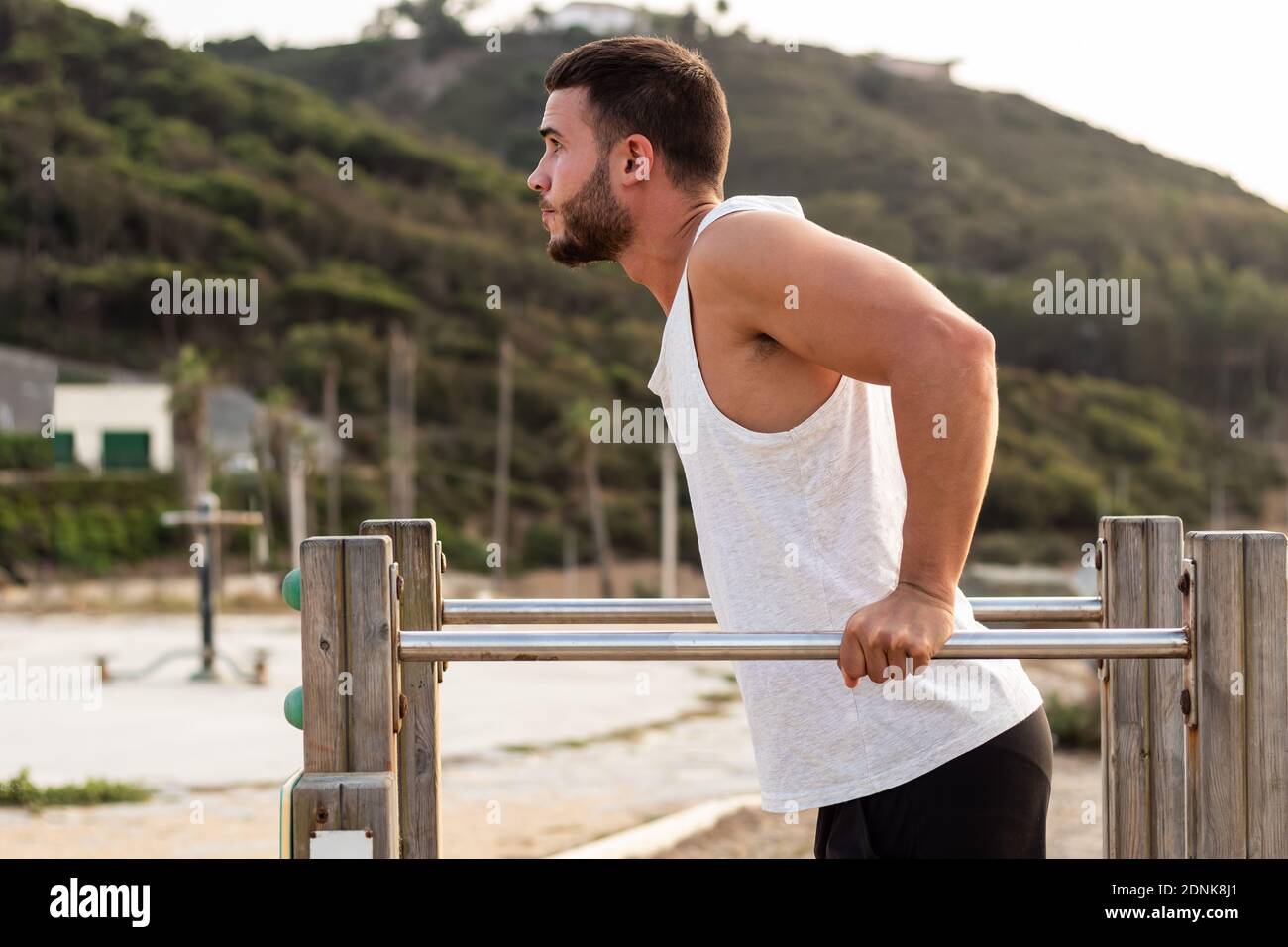 Young man doing push-ups in an outdoor park Stock Photo - Alamy