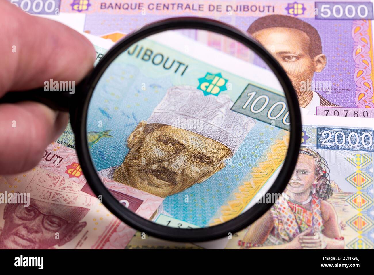 Djiboutian money in a magnifying glass Stock Photo