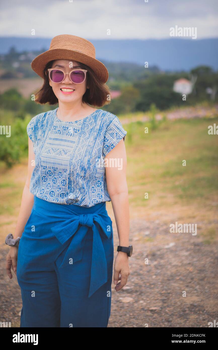 asian woman standing outdoor with toothy smiling Stock Photo