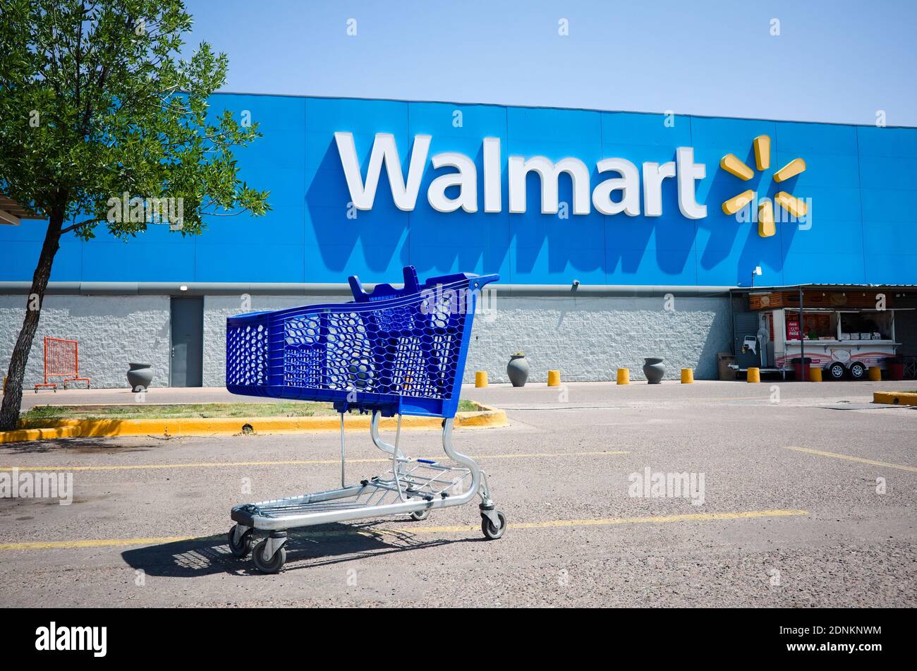 Mendoza, Argentina - January, 2020: Shopping cart on a parking lot in front of main entrance to Walmart supermarket outdoor on the street with no peop Stock Photo