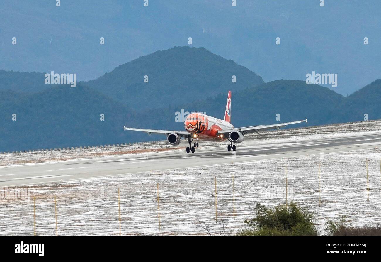 Chongqing. 18th Dec, 2020. The first flight lands at Xiannyushan Airport in southwest China's Chongqing, Dec. 18, 2020. Xiannyushan Airport, the fifth civil airport in Chongqing, officially opened on Friday. The airport is located 1745.04 meters above sea level, with a total terminal area of 6,000 square meters. Credit: Liu Chan/Xinhua/Alamy Live News Stock Photo