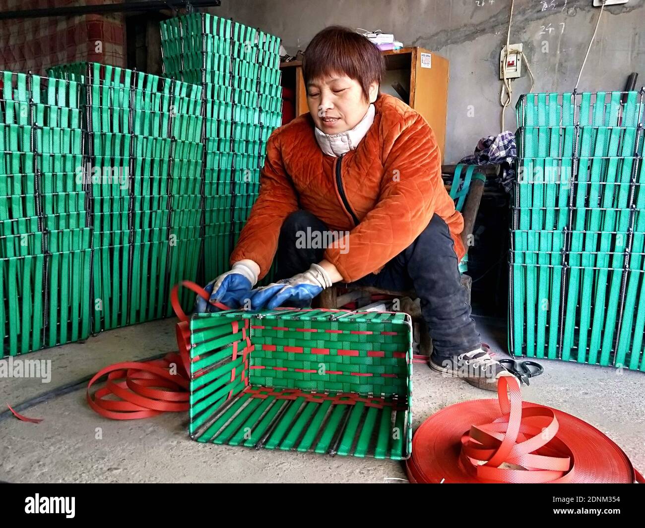 Yunmeng, Yunmeng, China. 18th Dec, 2020. Hubei, CHINA-On December 16, 2020, in Xiaogan City, Hubei Province, yuan Jinying, a disabled man with double legs, welded and woven steel frame basket at home.Disabled as she was, she not only made the house clean and tidy with her hardworking hands, but also helped her son finish his college education and finally lifted the family out of poverty.Introduced by villagers and friends, Yuan jinying's small workshop became increasingly famous.In 2018, the annual income of the small workshop reached 6,000 yuan, and Yuan Jinying became a banner of po Stock Photo