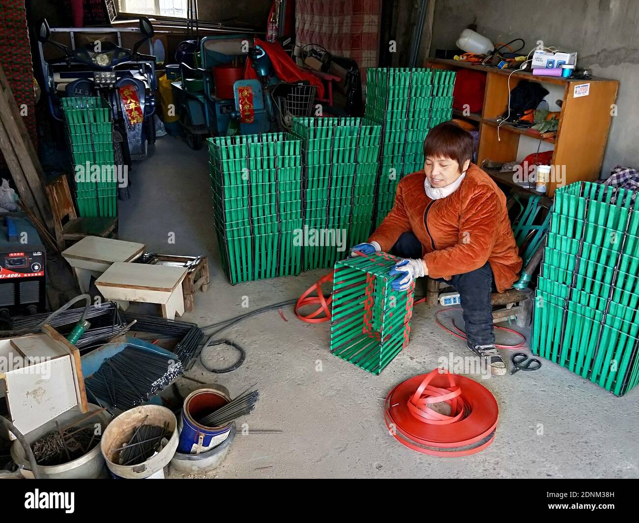 Yunmeng, Yunmeng, China. 18th Dec, 2020. Hubei, CHINA-On December 16, 2020, in Xiaogan City, Hubei Province, yuan Jinying, a disabled man with double legs, welded and woven steel frame basket at home.Disabled as she was, she not only made the house clean and tidy with her hardworking hands, but also helped her son finish his college education and finally lifted the family out of poverty.Introduced by villagers and friends, Yuan jinying's small workshop became increasingly famous.In 2018, the annual income of the small workshop reached 6,000 yuan, and Yuan Jinying became a banner of po Stock Photo