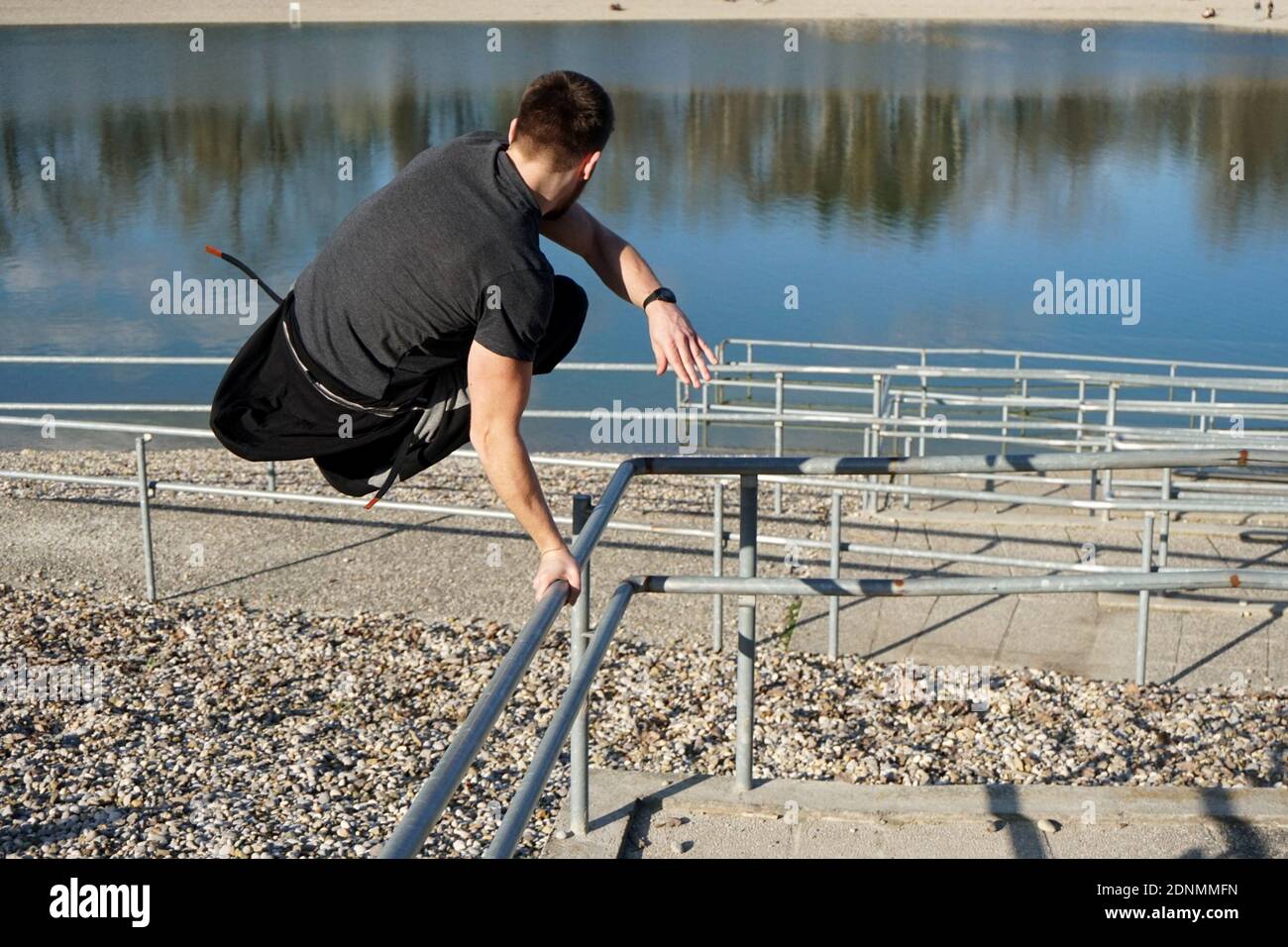 Young man jumping over railing hires stock photography and images Alamy