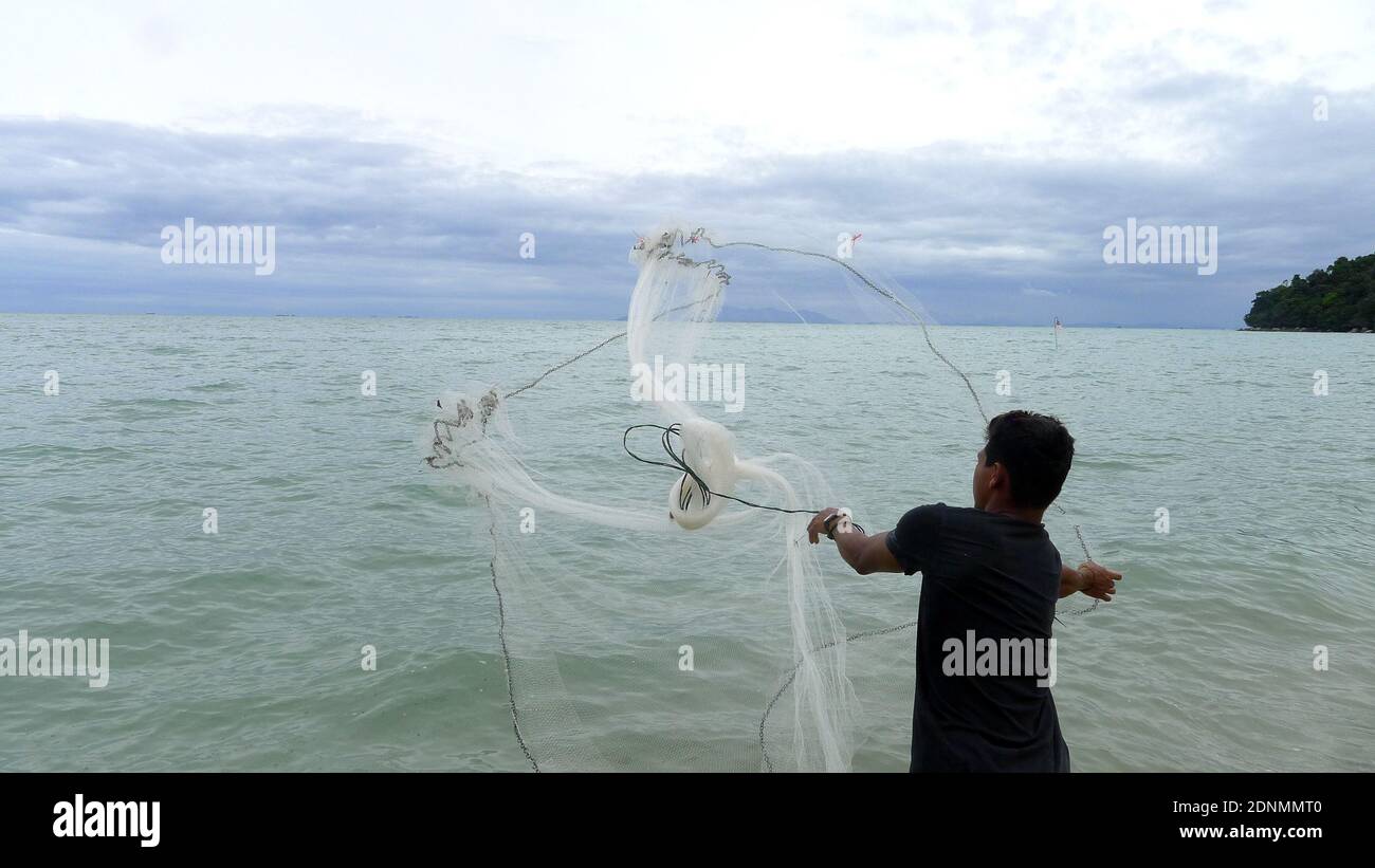 https://c8.alamy.com/comp/2DNMMT0/fisher-man-throwing-fishing-net-for-catching-fish-for-food-2DNMMT0.jpg
