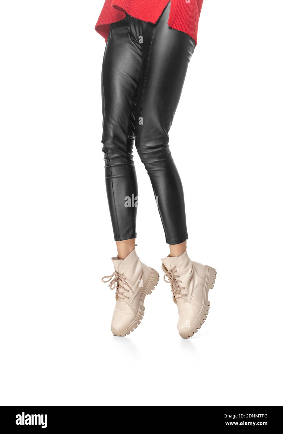 Shapely female legs in leather leggings and boots isolated on white ...