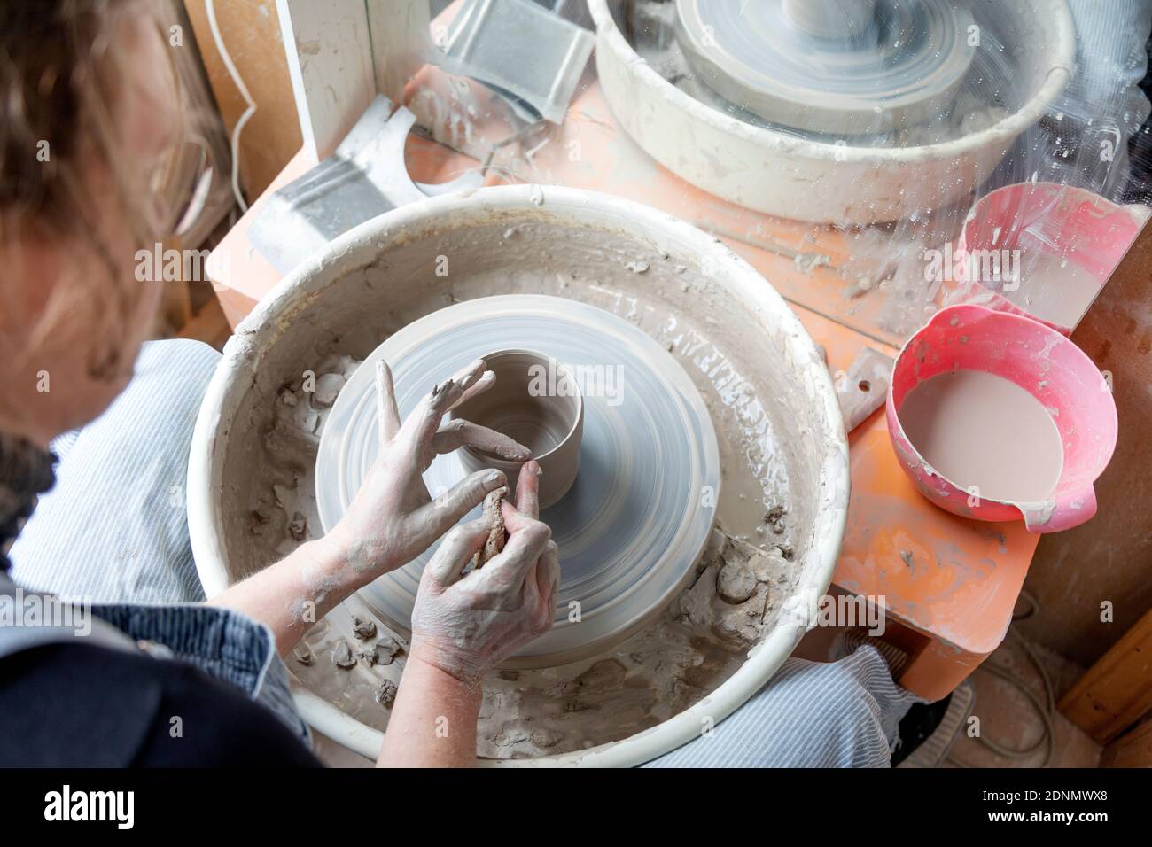 Woman using potters wheel Stock Photo