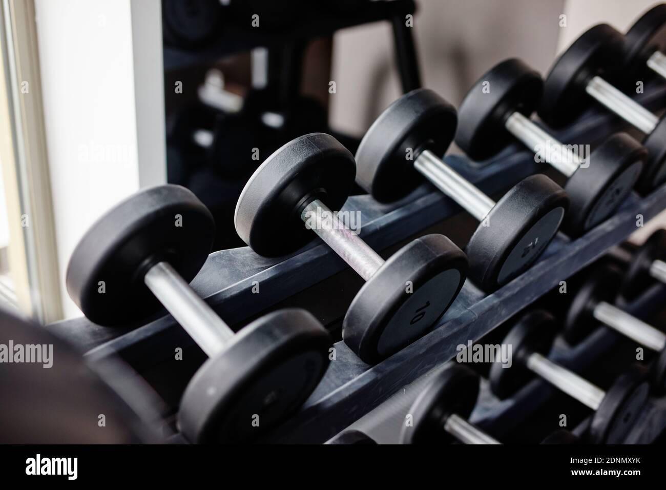 Dumbbells on rack Stock Photo - Alamy
