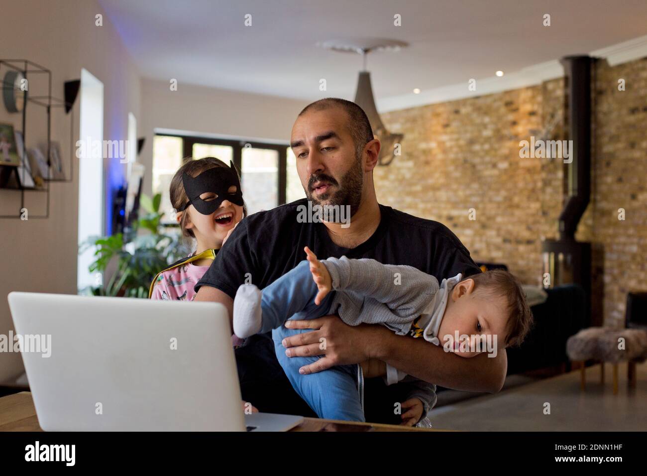 Man with children using laptop Stock Photo