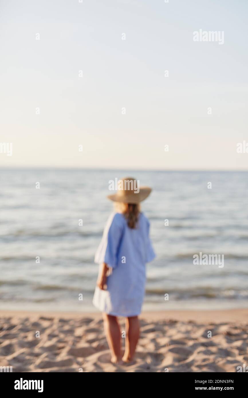 Woman standing on beach Stock Photo - Alamy