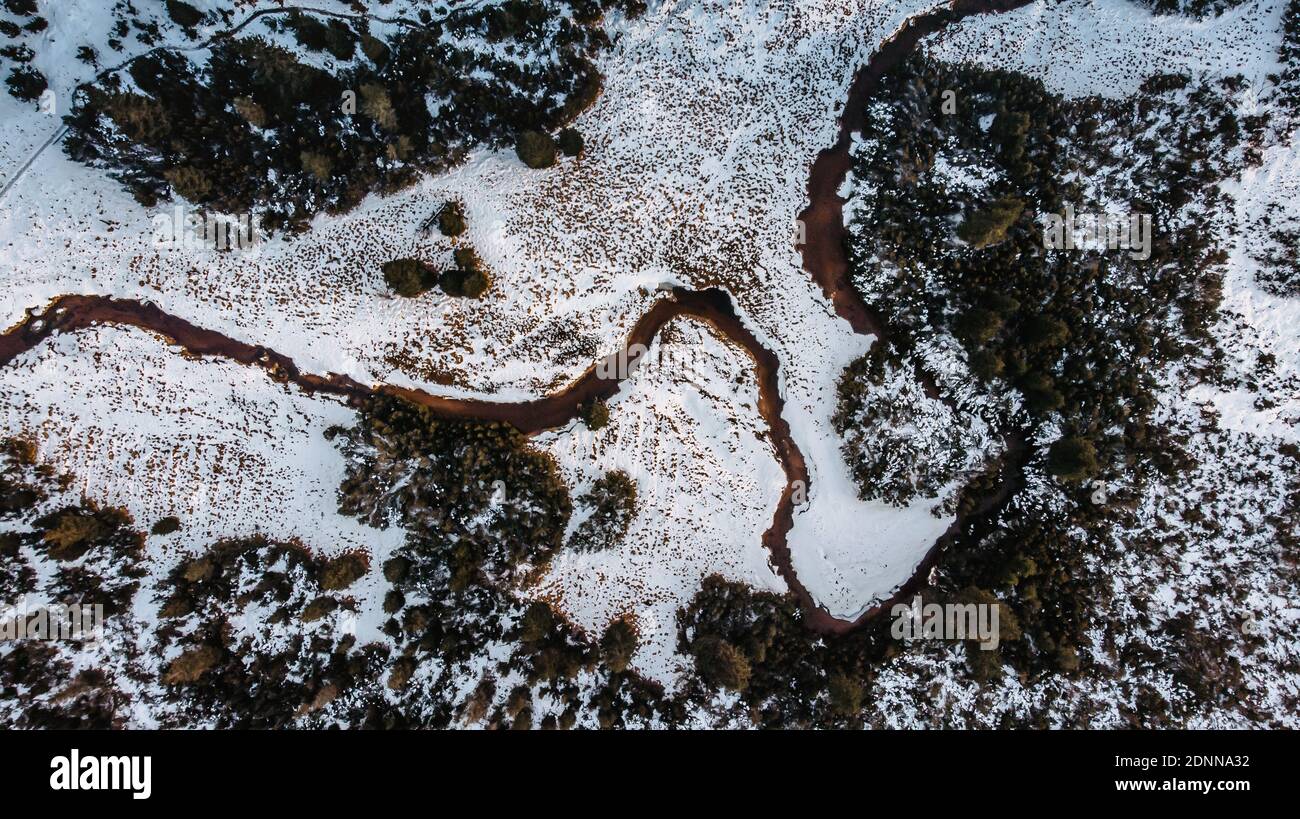 Aerial view of river stream.The river zigzags through the countryside.Meander of Jizerka river,Czech republic.Winter aerial landscape of river coast Stock Photo
