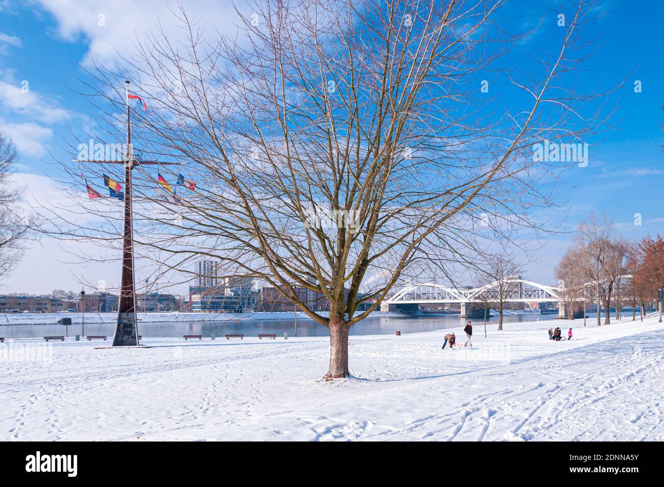 Mannheim, Germany. January 31th, 2010. In the morning, people stroll on the snow-covered meadows near the Rhine River. Stock Photo