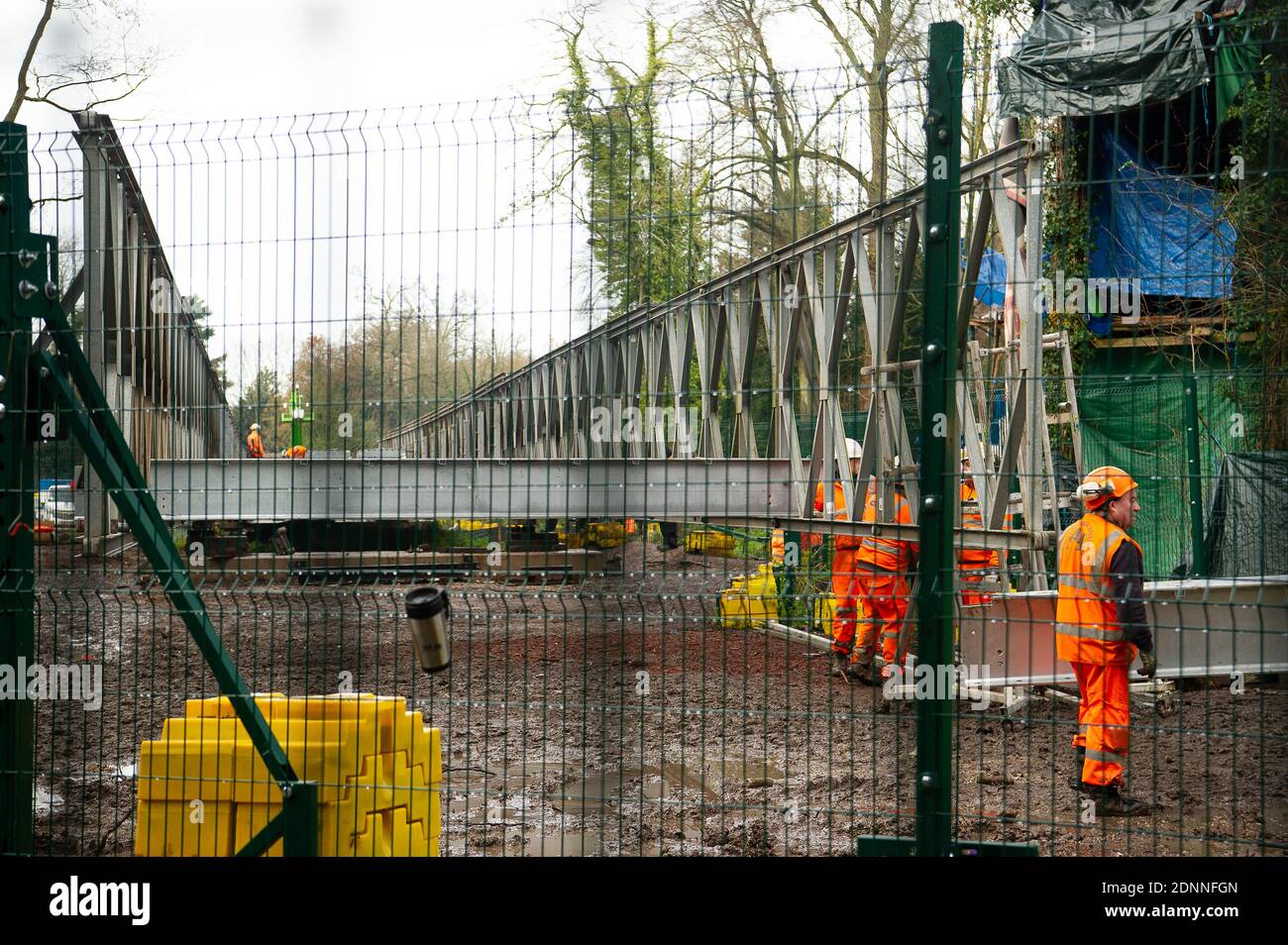 Denham, Buckinghamshire, UK. 9th December, 2020. Having already destroyed a big area of woodland, HS2 have now moved into place a temporary access bridge across the River Colne in Denham Country Park to enable heavy machinery into the irreplaceable wet woodlands and SSSI. HS2 Rebillion and environmental activists are living in tree houses high in ancient trees next to the bridge trying to save them from the destructive chain saws of HS2 Ltd. Credit: Maureen McLean/Alamy Stock Photo