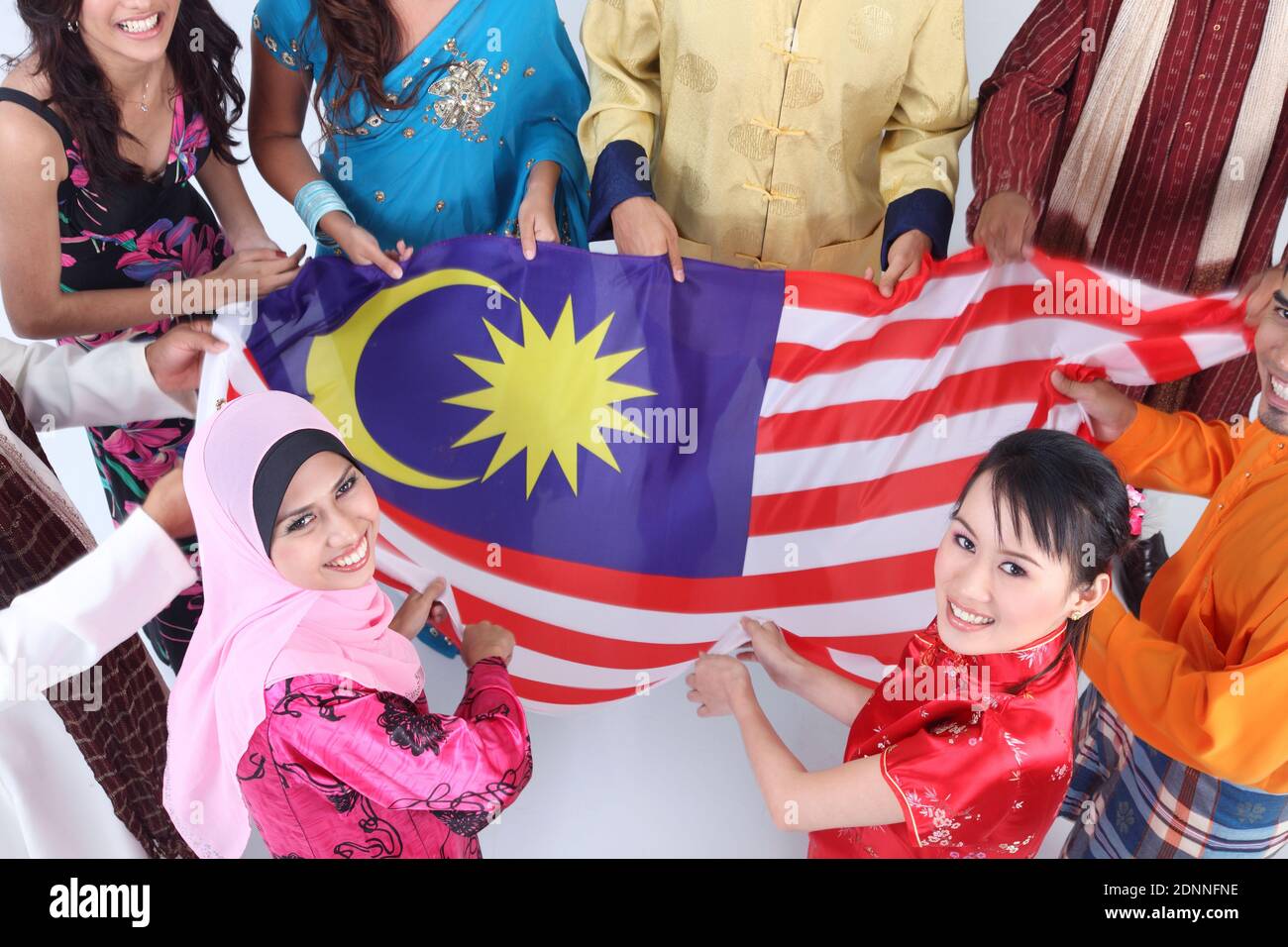 High Angle View Of Friends Holding Malaysian Flag Over White 