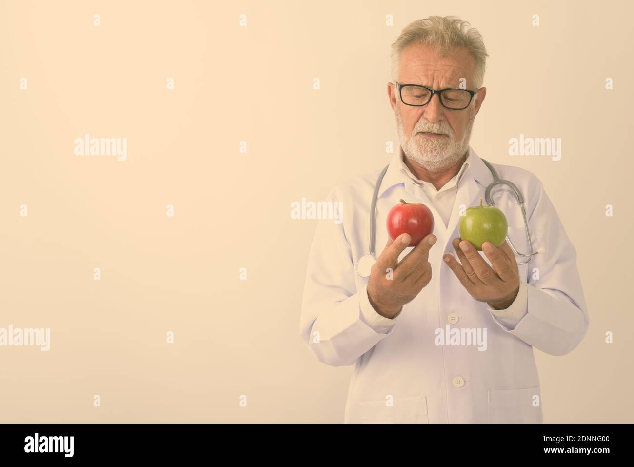 Bearded man choosing between apple hi-res stock photography and images ...