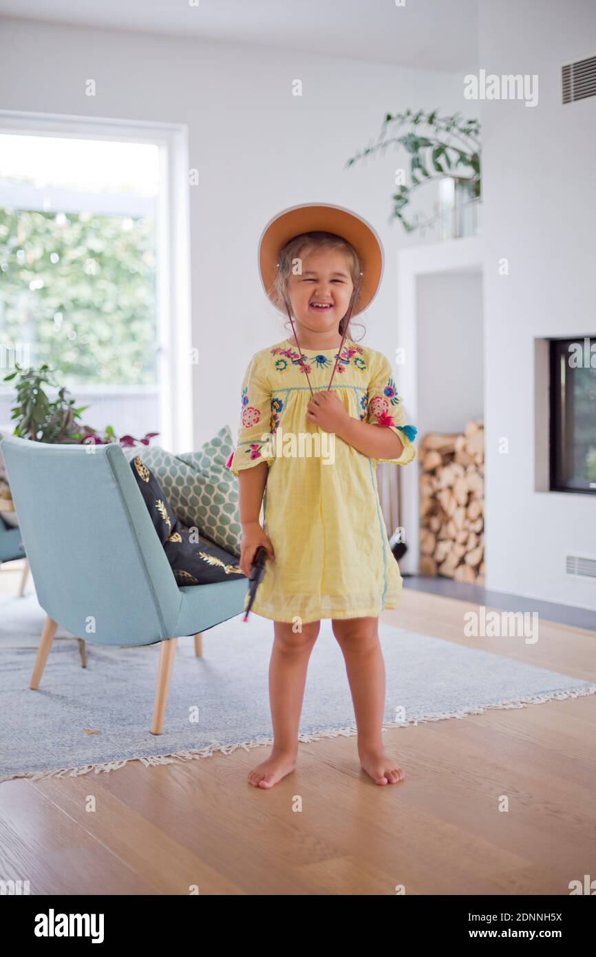 Girl holding pistol and wearing cowboy hat Stock Photo