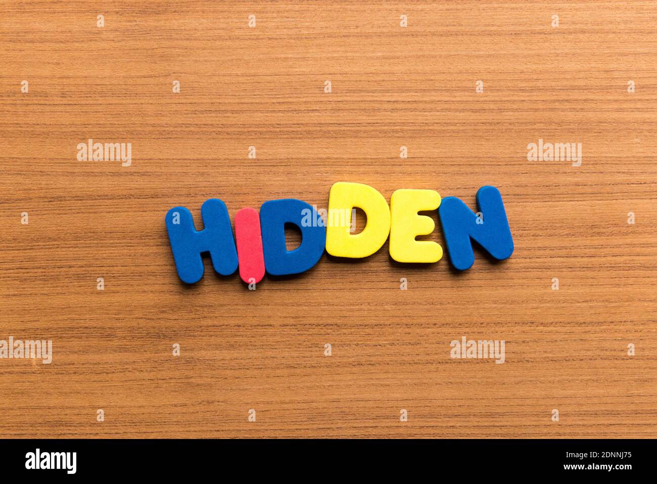 High Angle View Of Colorful Hidden Text On Wooden Table Stock Photo
