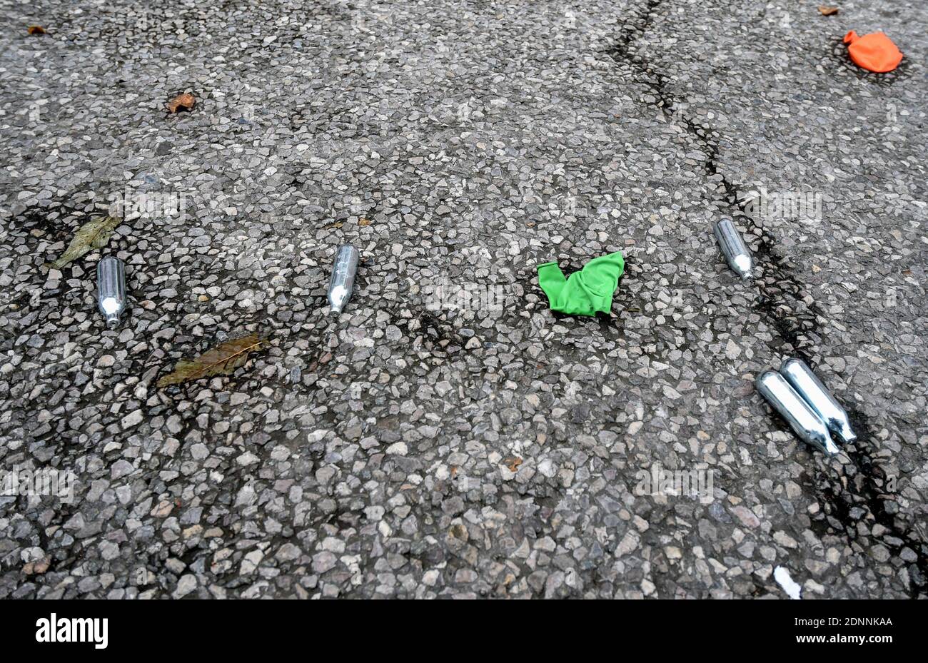 Nitrous oxide canisters and balloons on the ground. These catering