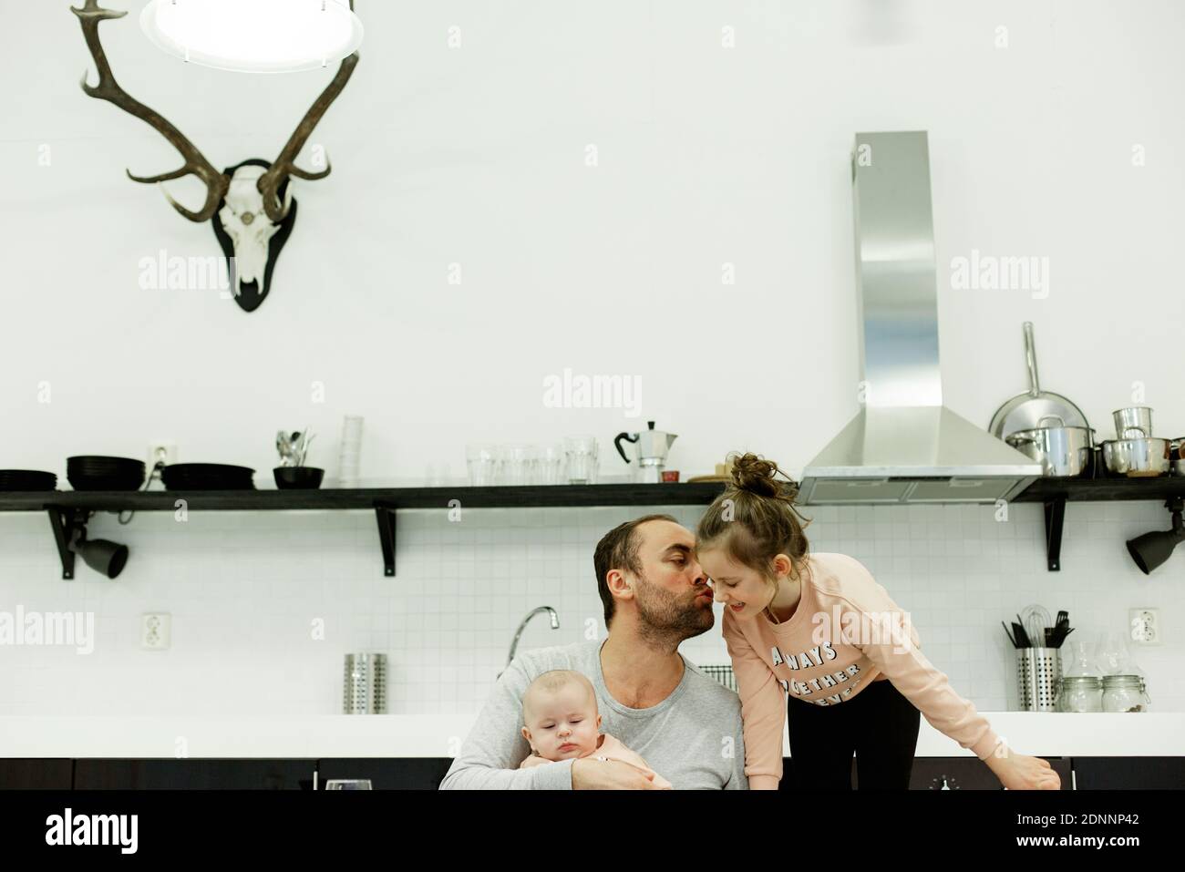 Father with children in kitchen Stock Photo