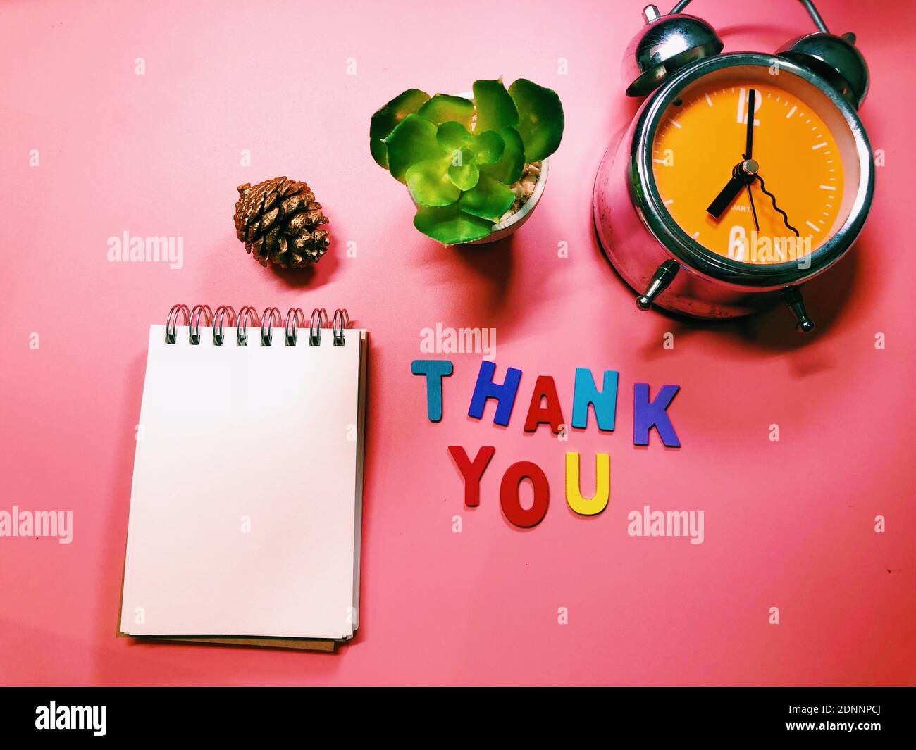 Directly Above Shot Of Spiral Notebook With Alarm Clock And Thank You Sign On Red Background Stock Photo Alamy