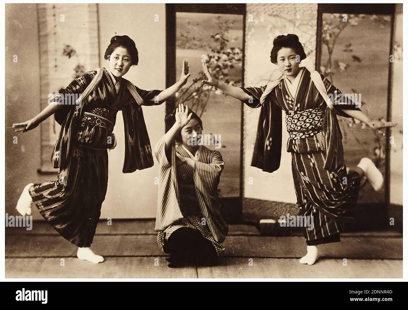 Three dancing women, albumin paper, black and white positive process, Total: Height: 12,50 cm; Width: 17,90 cm, travel photography, portrait photography, group portrait, full-length portrait, dancing, young woman, girl, screen, screen, folk costume, regional costume Stock Photo