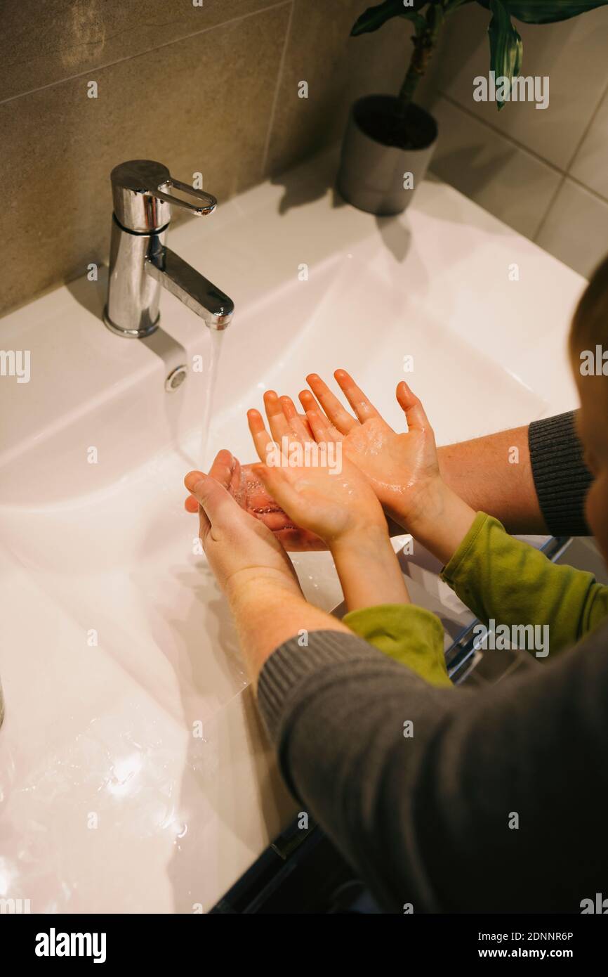 Father with child washing hands Stock Photo