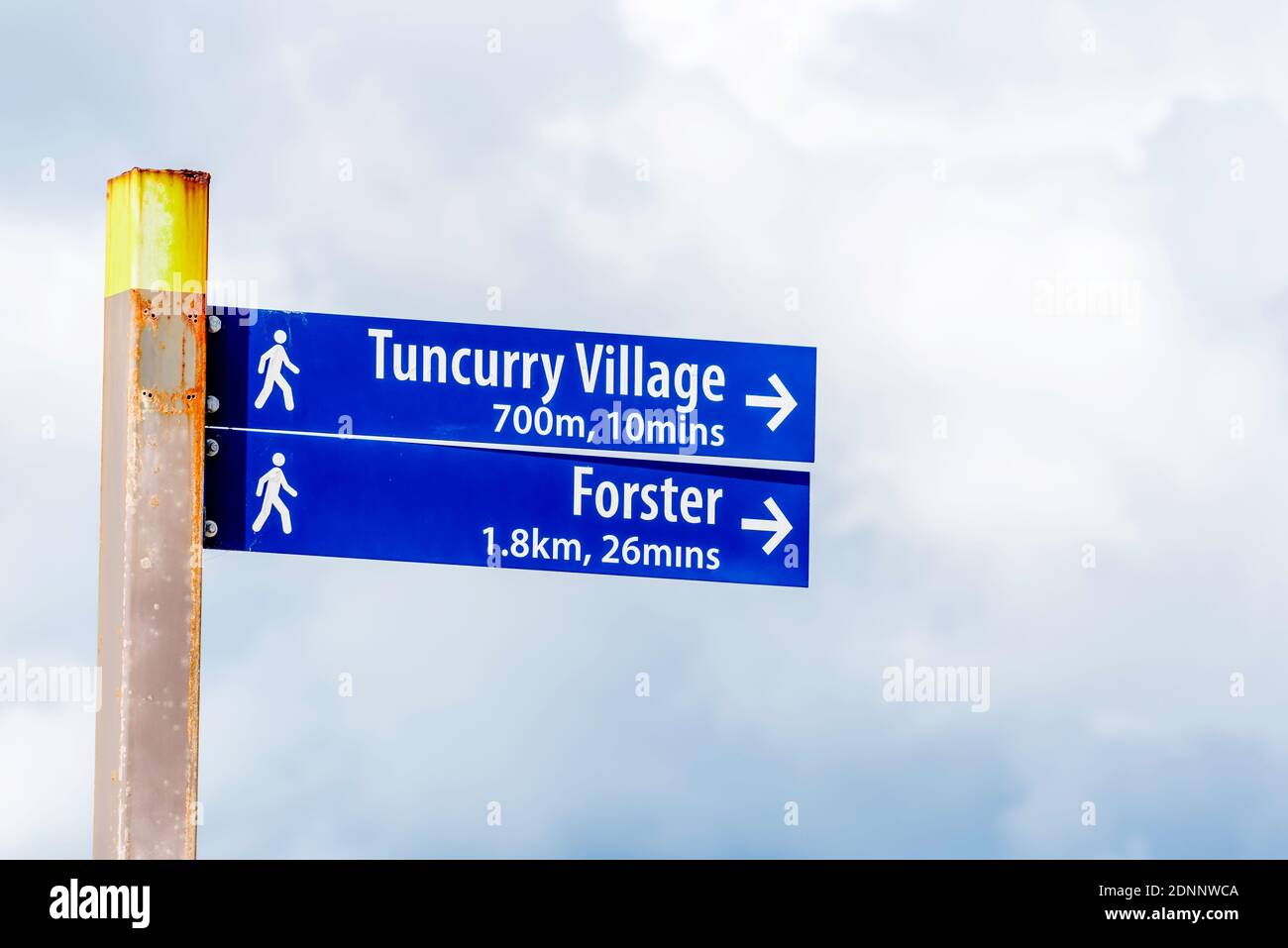 A street sign and sign post providing distance and walking time to locations in Forster Tuncurry, New South Wales, Australia Stock Photo