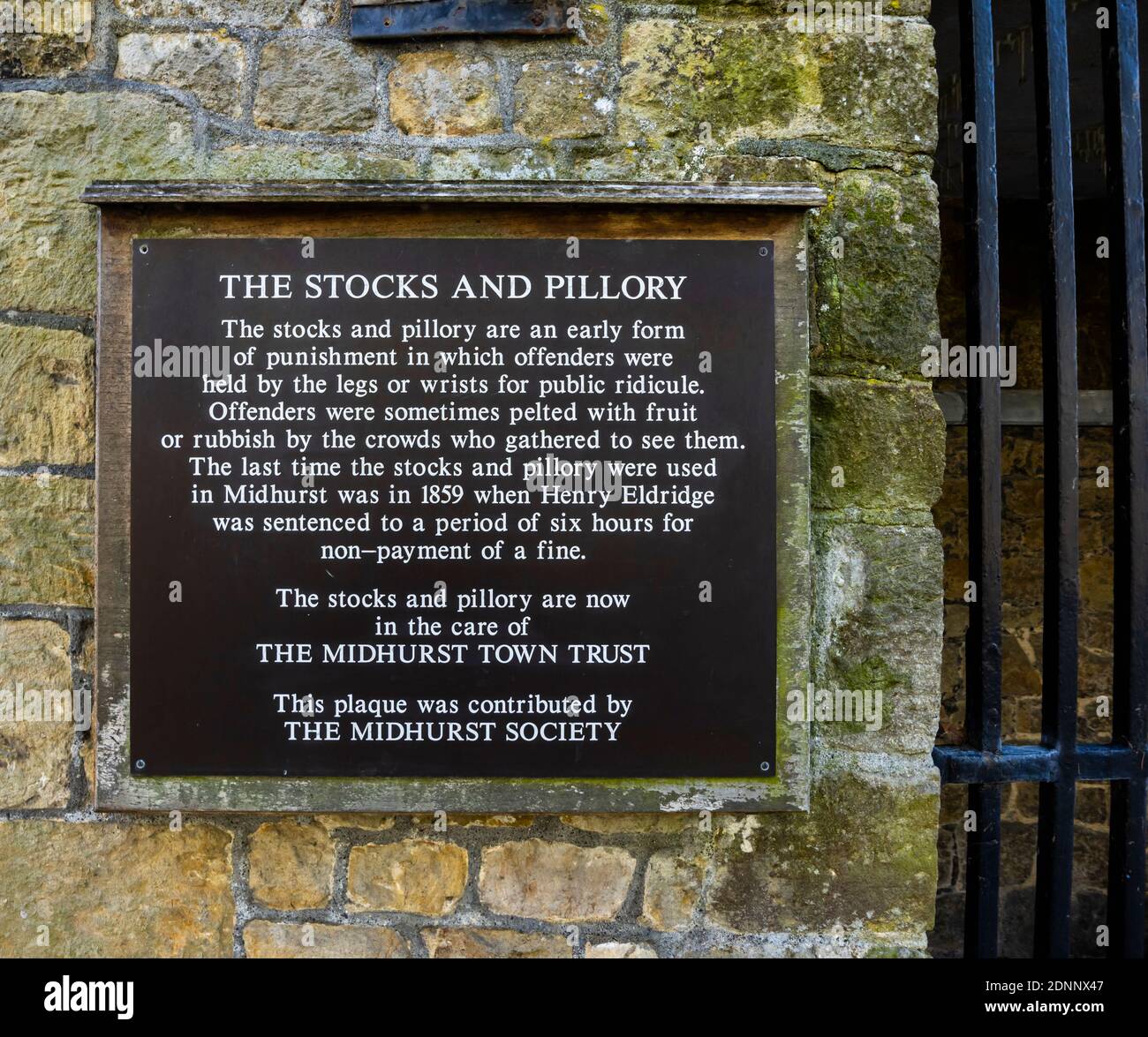 Infrmation sign about the vintage 19th century stocks and pillory in Midhurst, a town in West Sussex, south-east England, last used in 1859 Stock Photo