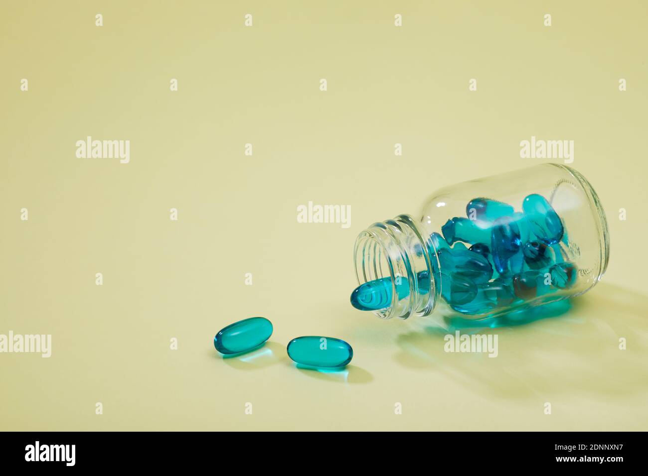 Blue capsules on pink background Stock Photo