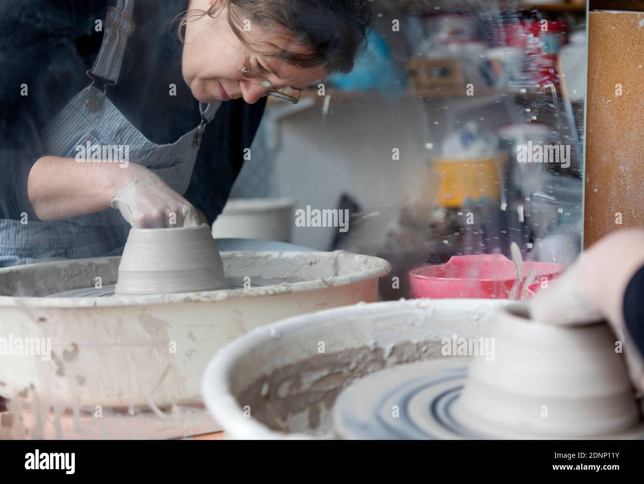 Woman using potters wheel Stock Photo
