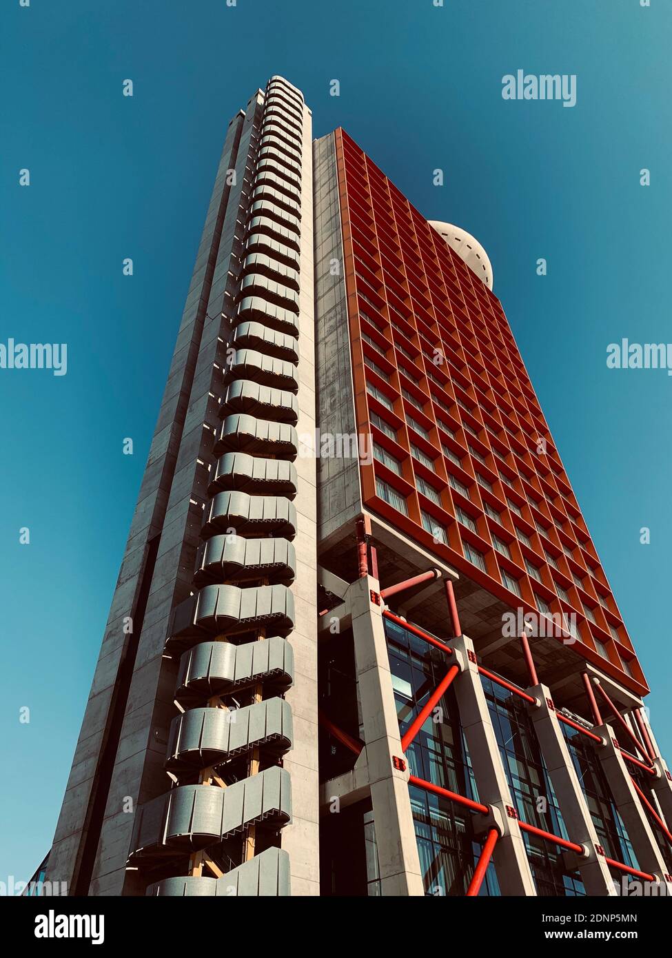 Low Angle View Of Modern Building Against Clear Blue Sky Stock Photo