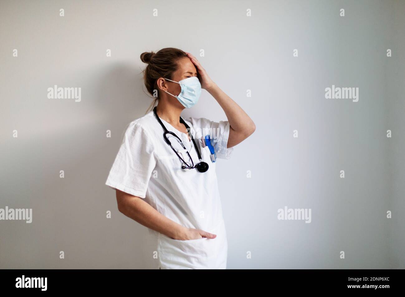 Female doctor wearing protective face mask Stock Photo
