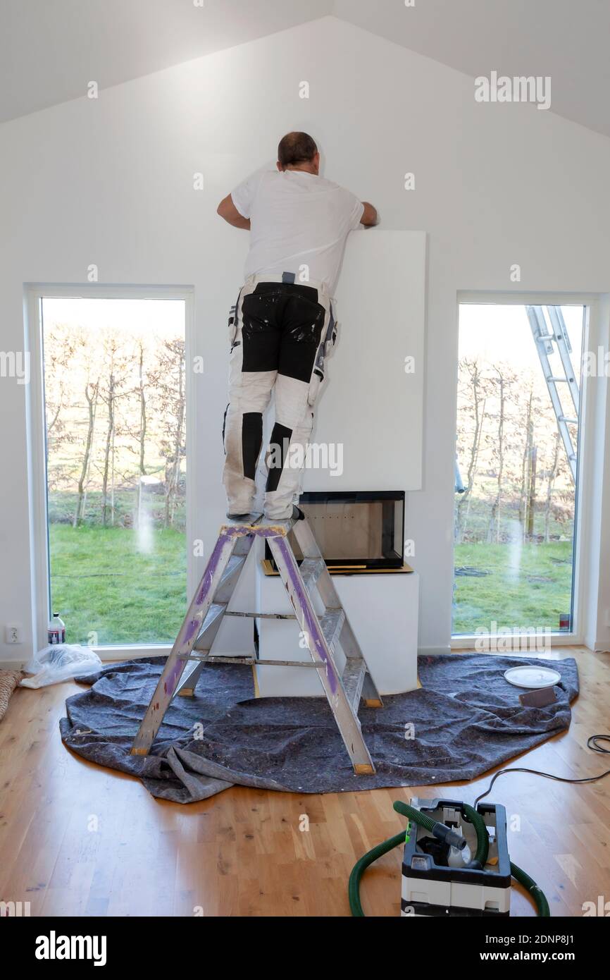 Man installing fireplace Stock Photo Alamy