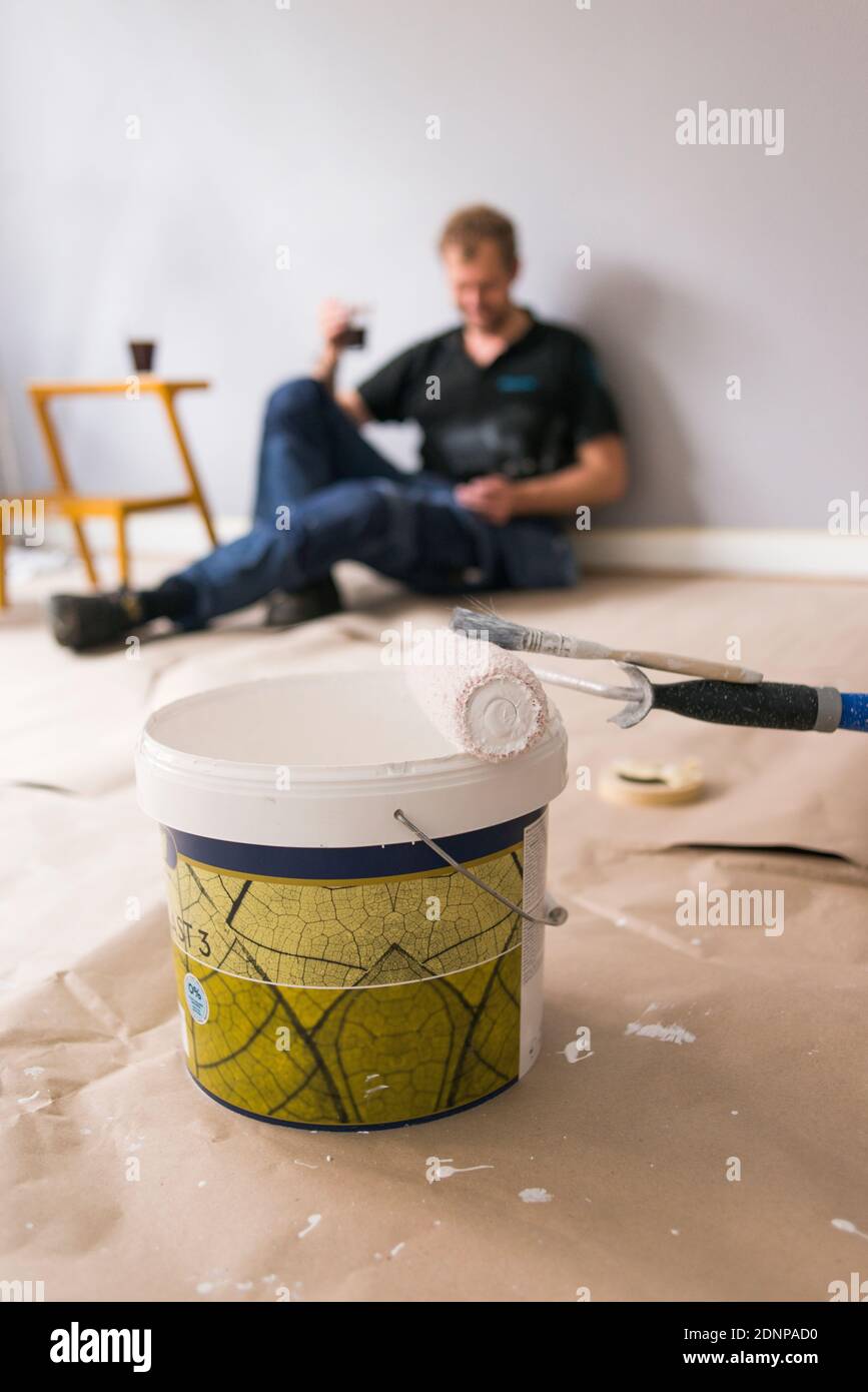 Paint roller and paint bucket in room Stock Photo Alamy