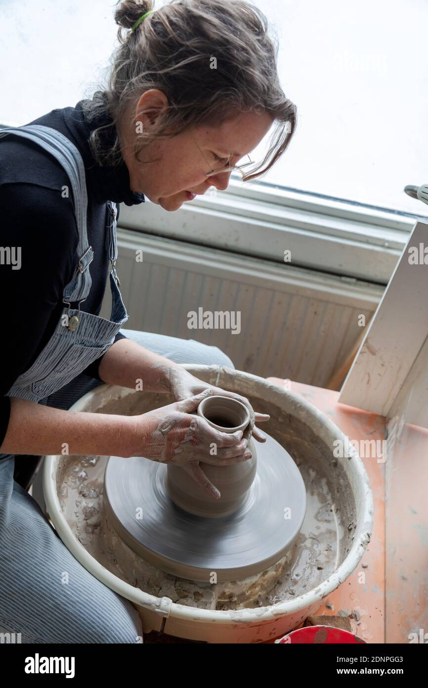 Woman using potters wheel Stock Photo