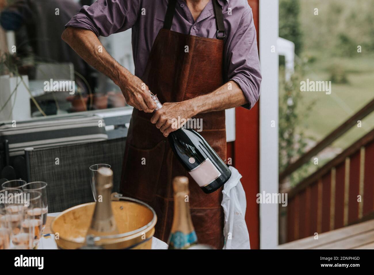 Man opening champagne bottle Stock Photo