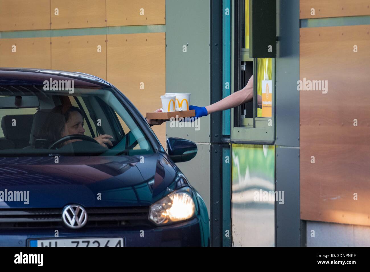 Warsaw, Poland - July 10, 2020: Fast Food drive, picking up food at the counter, driveway for cars at the restaurant. Eating in the car. Stock Photo