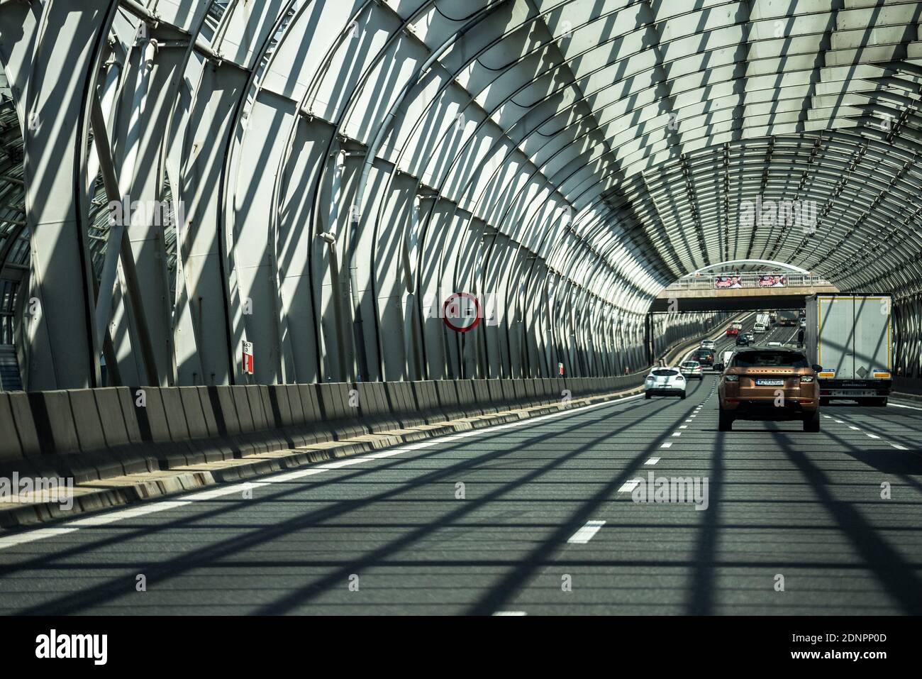Warsaw, Poland - July 10, 2020: Traffic in Warsaw, tunnel on Trasa Toruńska. The sun passes through the metal structure. Stock Photo