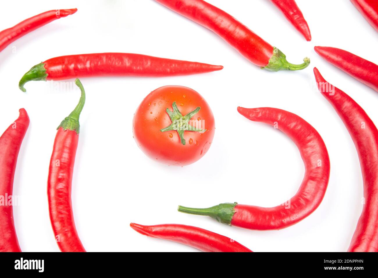 Red hot chili peppers and tomato on a white background. Vitamin