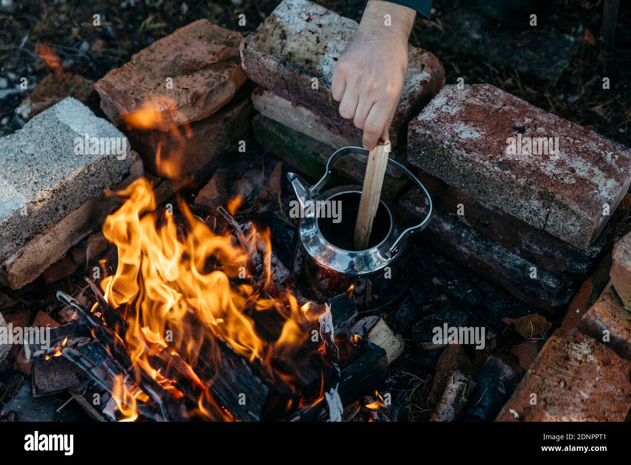 Hand mixing in kettle over log fire Stock Photo Alamy