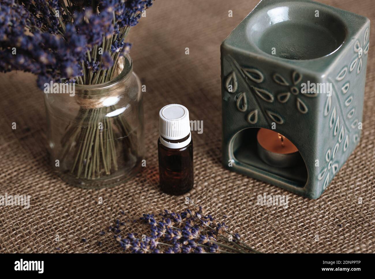 Close up of aroma lamp with burning candle and essential lavender oil, an  aromatherapy concept Stock Photo - Alamy