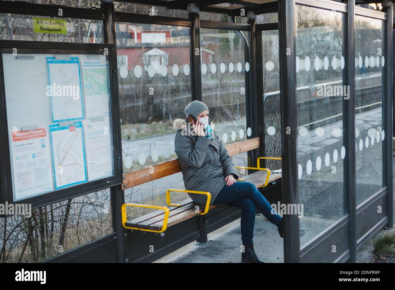 Woman waiting on train station platform Stock Photo
