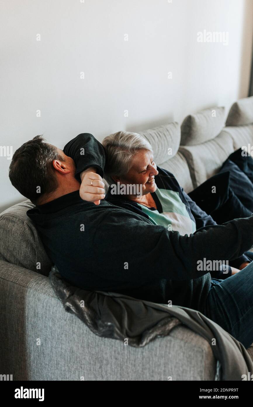 Mature couple sitting on sofa Stock Photo