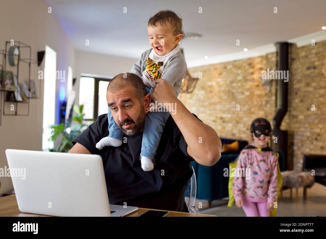 Man with children using laptop Stock Photo