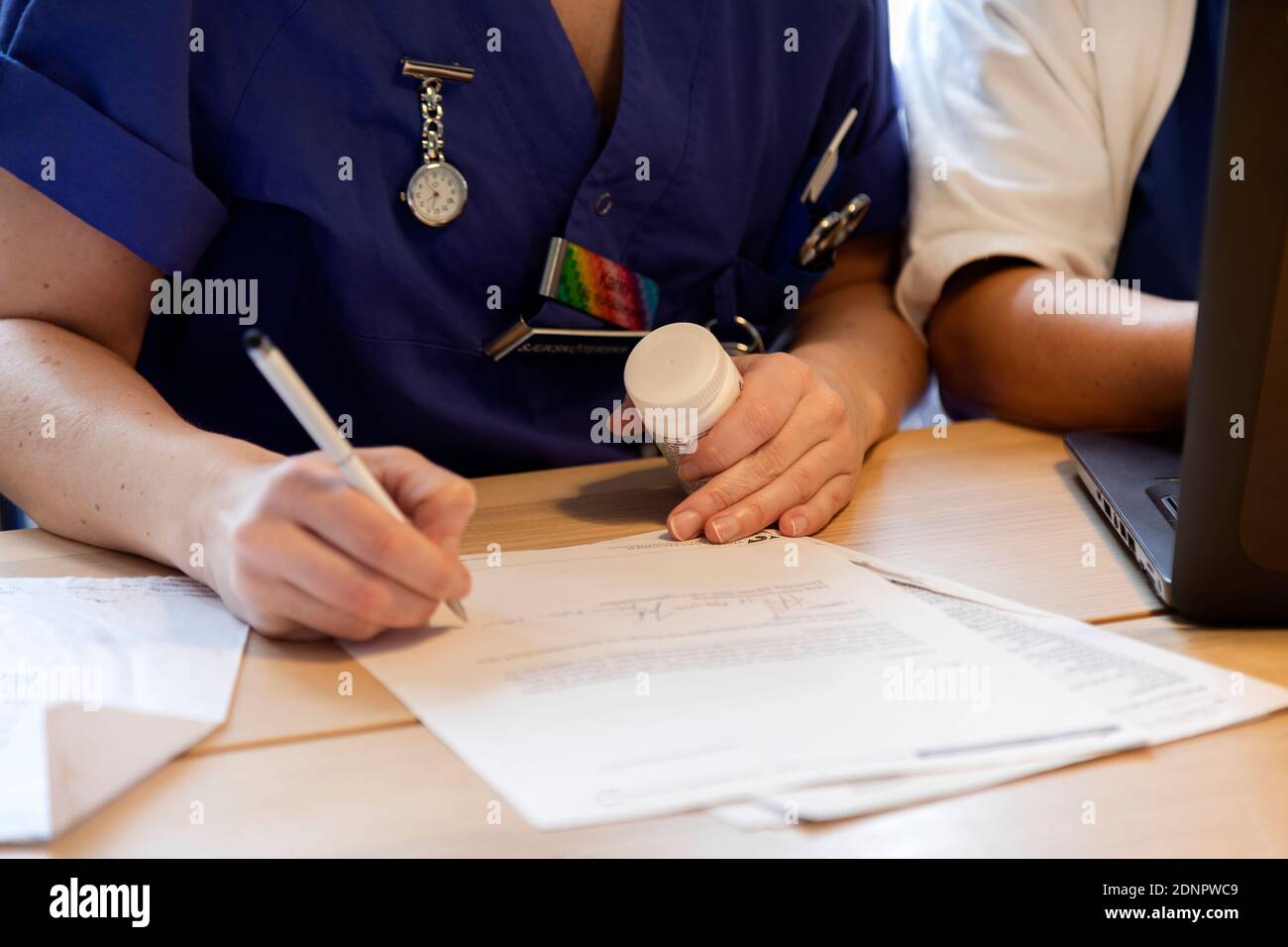 Nurses hand writing Stock Photo