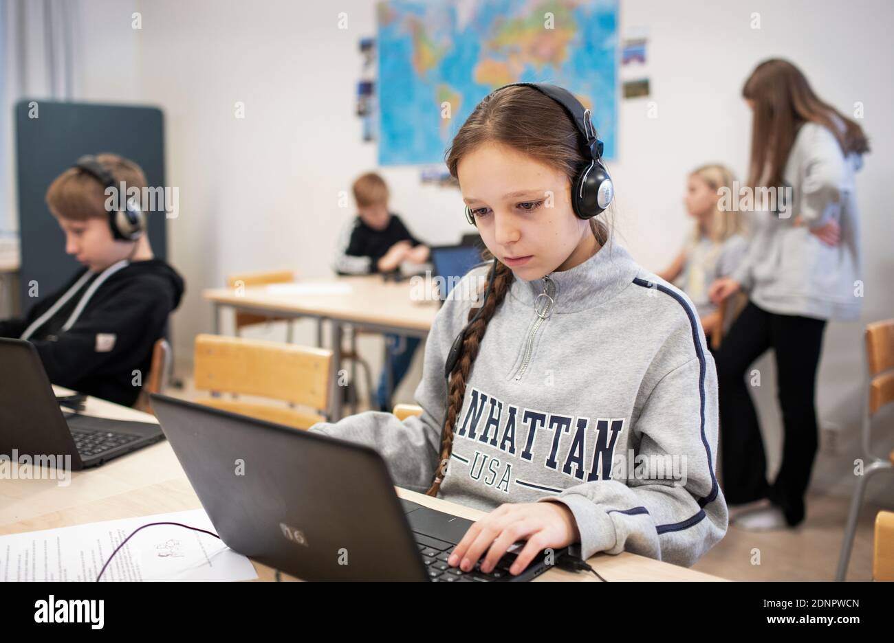 Girl in classroom using laptop Stock Photo - Alamy