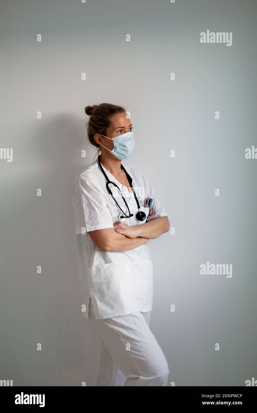Female doctor wearing protective face mask Stock Photo