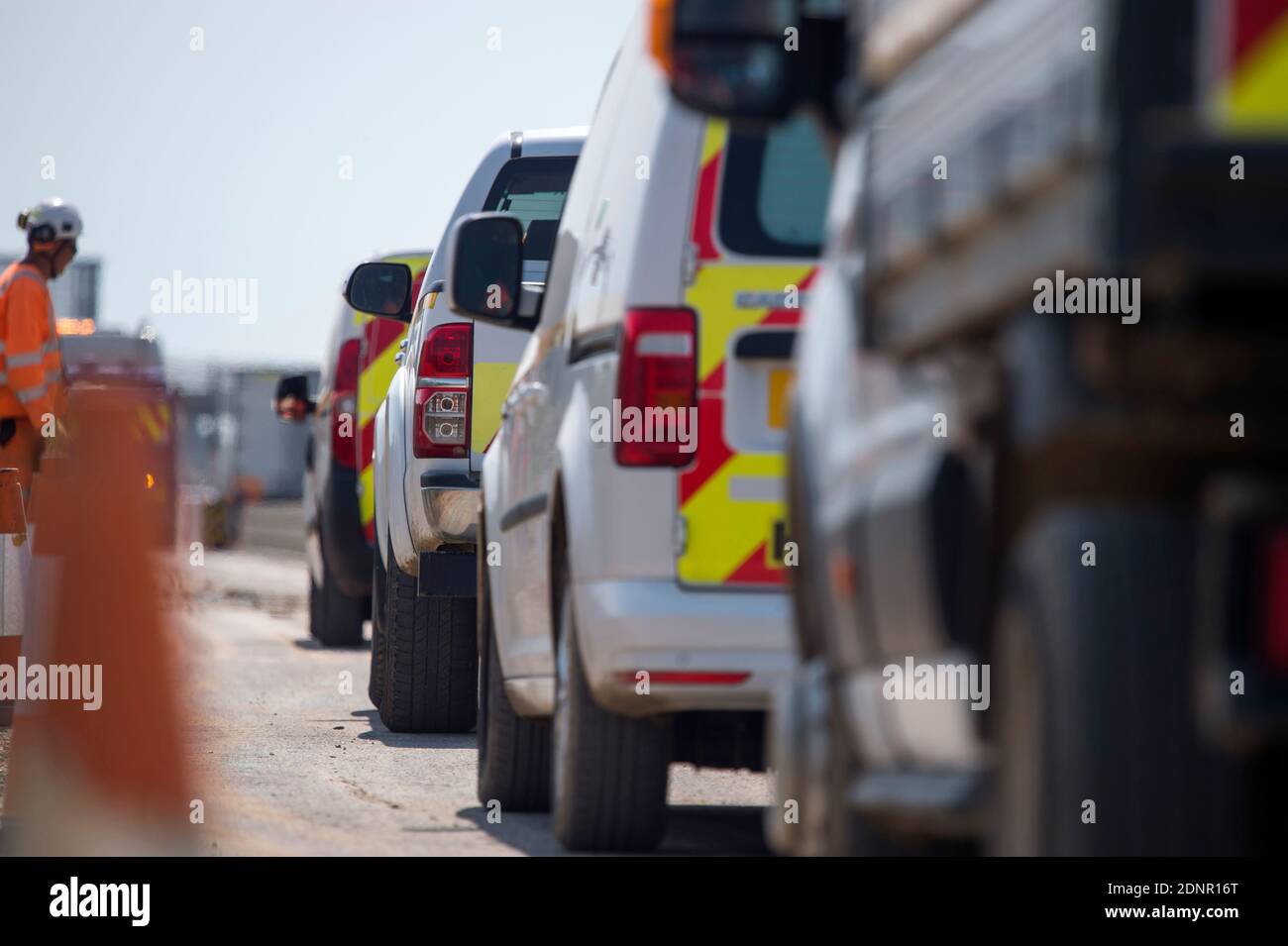 Queue of motorway maintenance vehicles in roadworks on the M1 motorway, England. Stock Photo